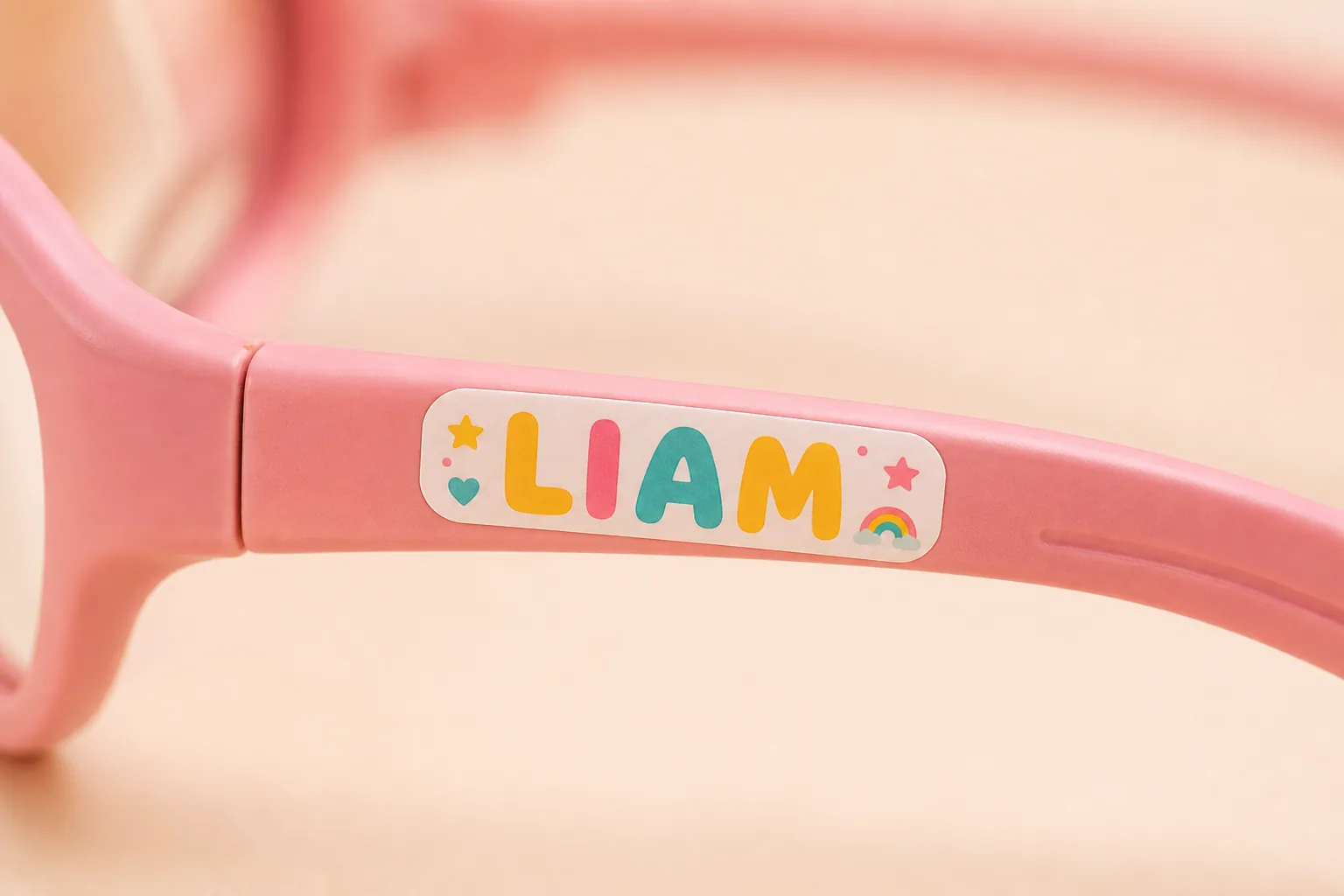 Child's name LIAM printed on pink blue-light glasses temple