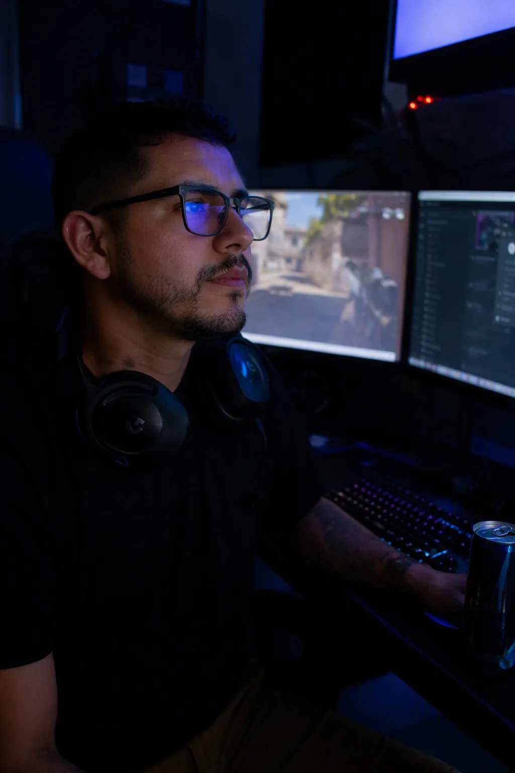 Hispanic man at triple monitor setup